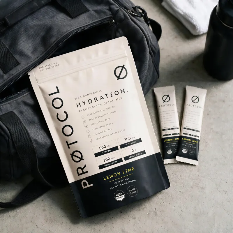 PRØTOCOL bag and stick packs beside a duffel and water bottle